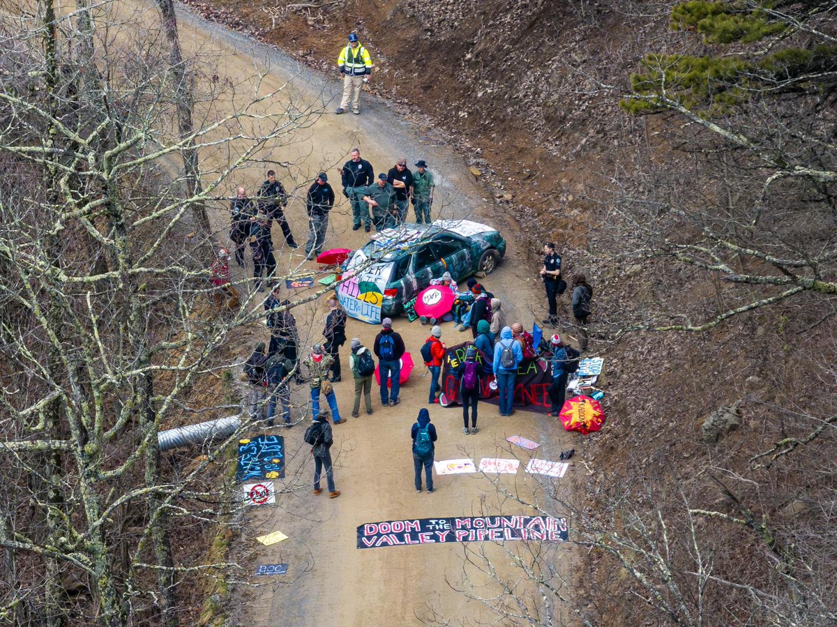 Andy has been extracted and arrested. Cops are still trying to remove the vehicle blockade from the road. Great work today River &amp; Andy delaying the Mountain Valley Pipeline! Every delay counts. 👏 (Photo cred: Musgrave Media Productions)