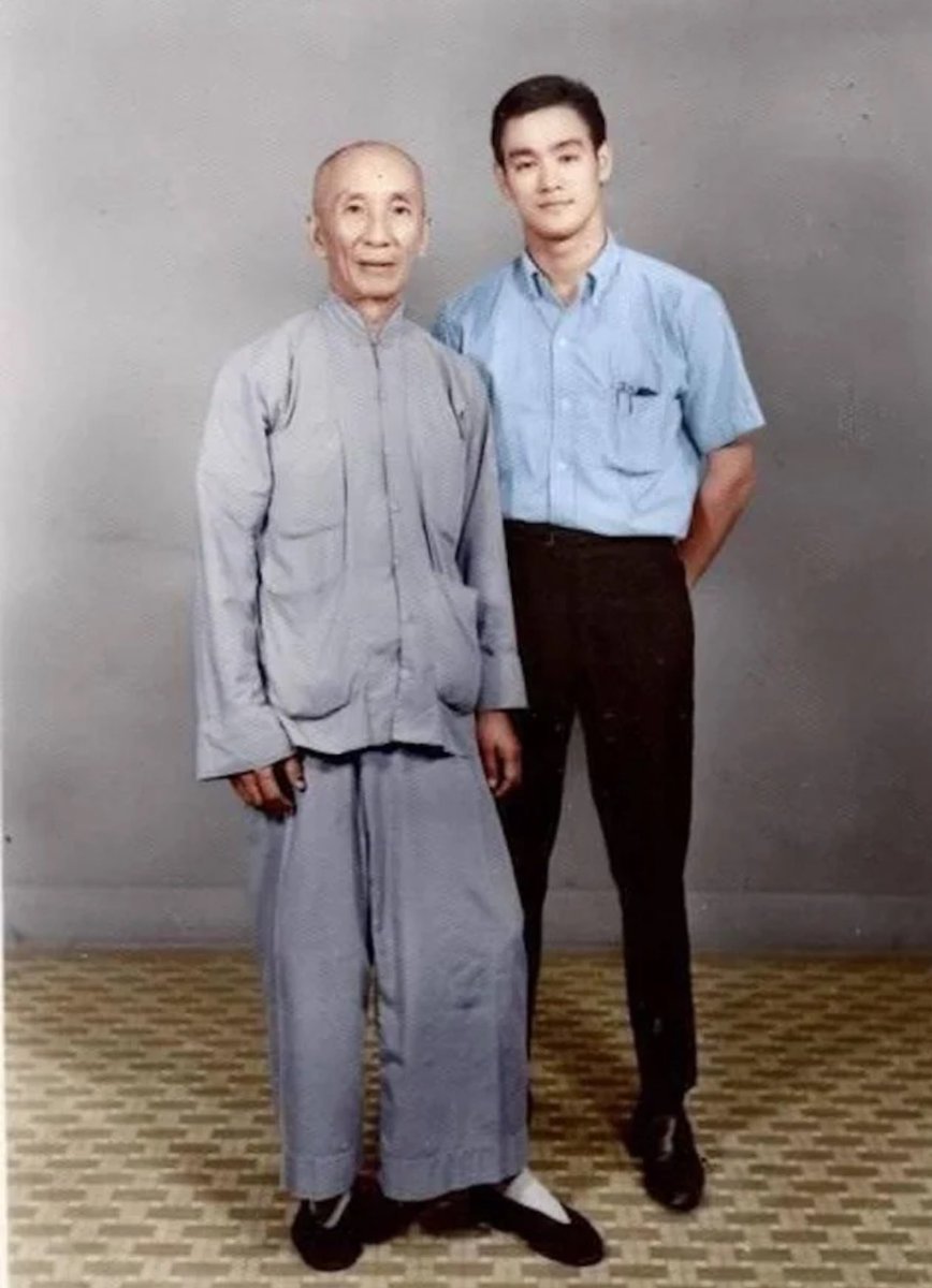 Bruce Lee with his grand master, Ip Man, 1960s.