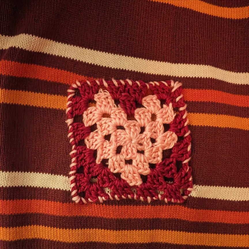 There was a hole in my sweater and when I couldn't get the hang of embroidery, I crocheted a little granny square patch with the thread! I'm pretty happy with how it looks. #crochet #patches #clothingrepair #mcsloveis #grannysquare