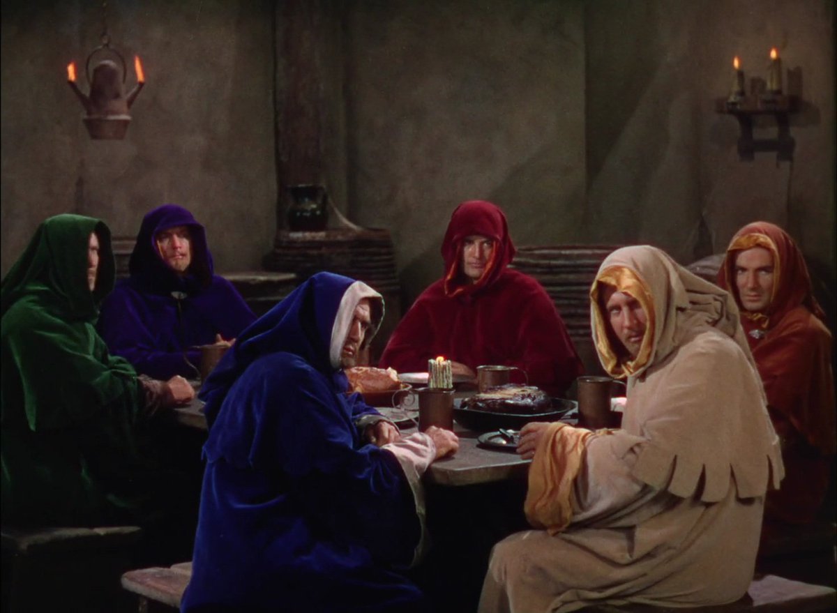 the funniest part of robin hood's absurdly showoffy technicolor extravaganza is this scene where six guys are in disguise but because it's warner bros' big technicolor breakout they're dressed like this