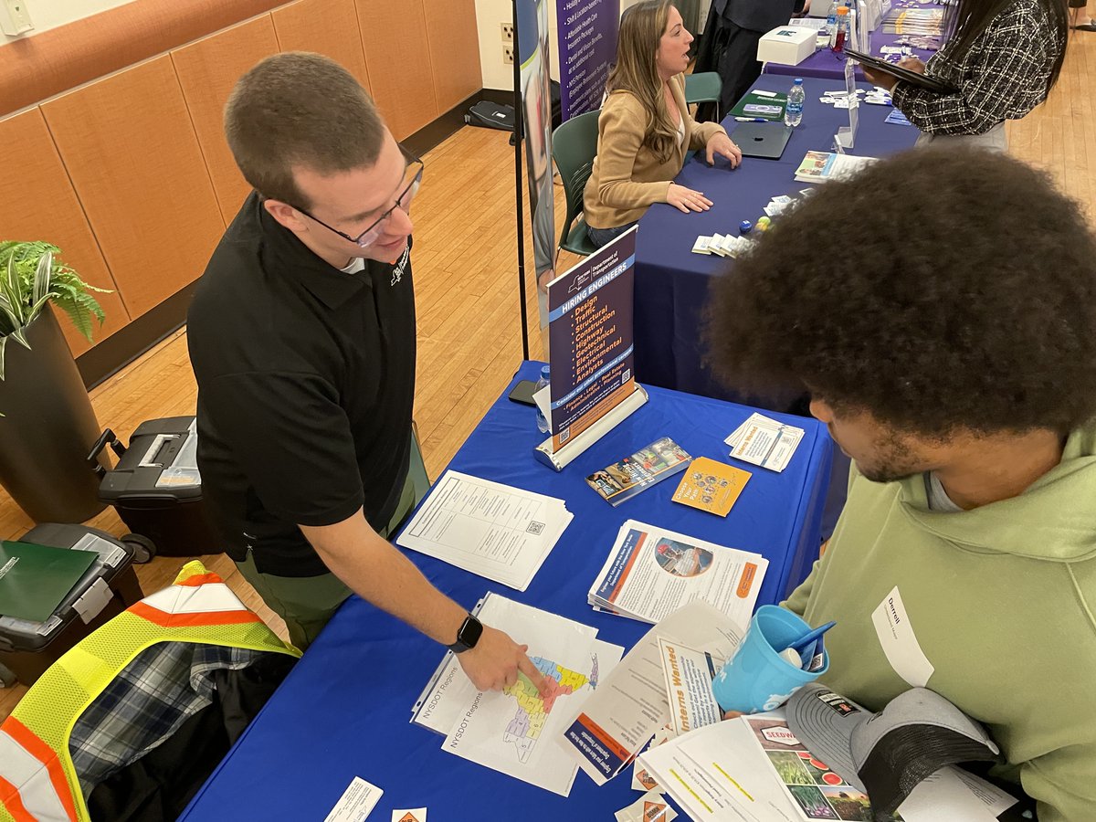 Design Engineer, Alex Prince, talks with a student about opportunities with <a href="/NYSDOT/">NYSDOT</a> at SUNY Binghamton's Job and Internship Fair.