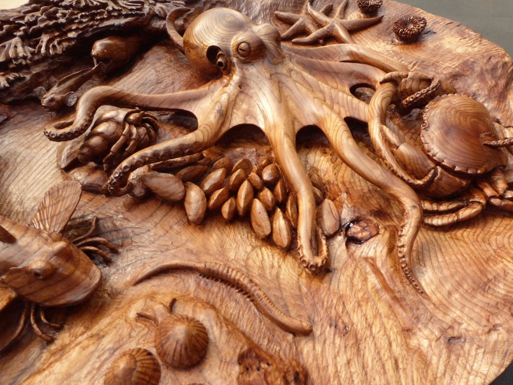 Another shot of my father's Rockpool Table centerpiece. Unlike the table's oak structure and remarkable leg carvings, this is hewn from a single solid block of Scottish elm. Viewed under glass, it appears to be underwater, and forms a unique, playful, functional sculpture.