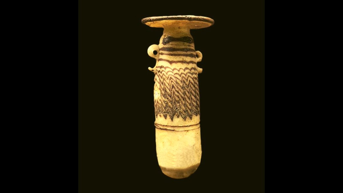 This delicate flask, measuring approximately two inches in height, was suspended with strings from the handles near its top. It was used to store precious perfumed oils. This beautiful piece is from the Late Period (525-343 BCE).