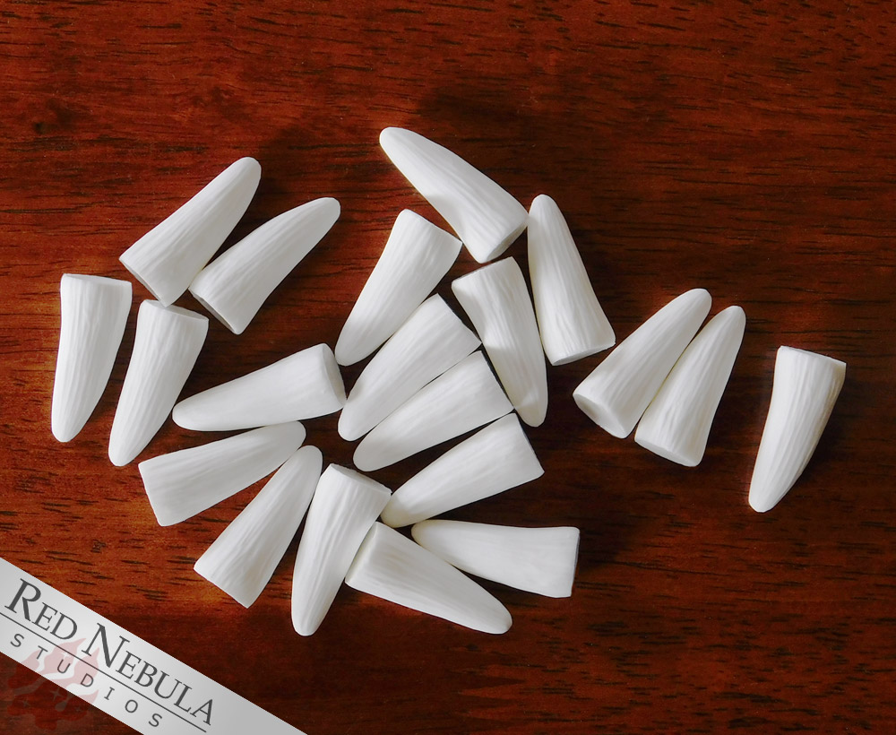 Resin cast ridged fangs, available raw or cleaned up, sized at 1 and 1.5 inch. - Robbie.