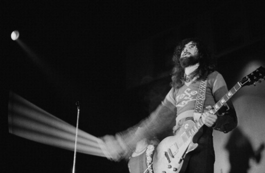 Jimmy Page using a violin bow on his guitar at the Empire Pool in Wembley, London, 1971. Photo by Michael Putland.