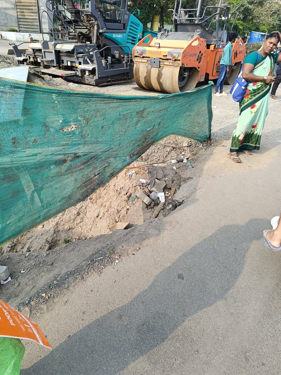 sent_hil's tweet photo. @chennaicorp Road continuously caving in near the open pit dug for rain water drain construction and left open. Passengers waiting for city bus are slipping and getting hurt. Location:  Thoraipakkam, opposite BSR Mall, in front of Mandarin Apartment. https://t.co/DhAfJB9fBo