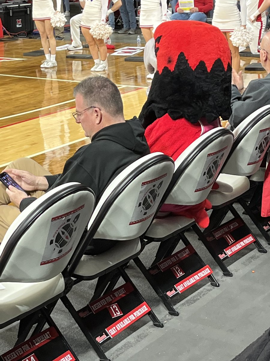 Miami football coach Chuck Martin and his “date” for the Eastern Michigan-RedHawks women’s basketball game.