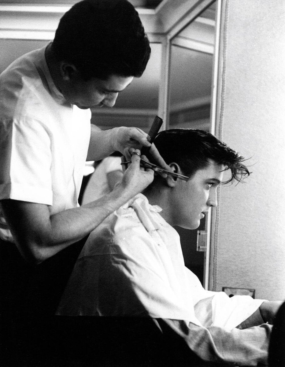 Elvis Presley in the barber's chair during production of Loving You (1957)