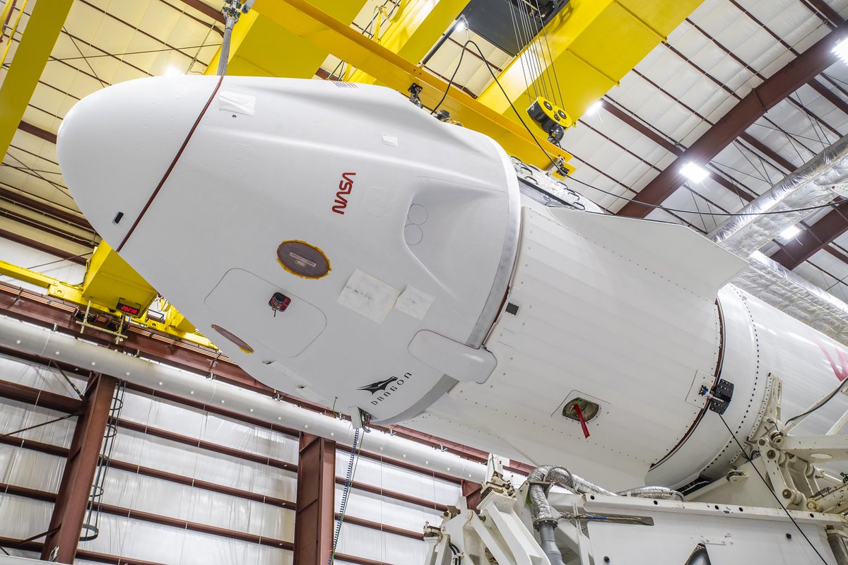 SpaceX teams mate the Crew-8 Dragon to its Falcon 9 rocket in the hangar at pad 39A in Florida