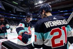 Borgen and Wennberg skating during warmups in winter classic jerseys