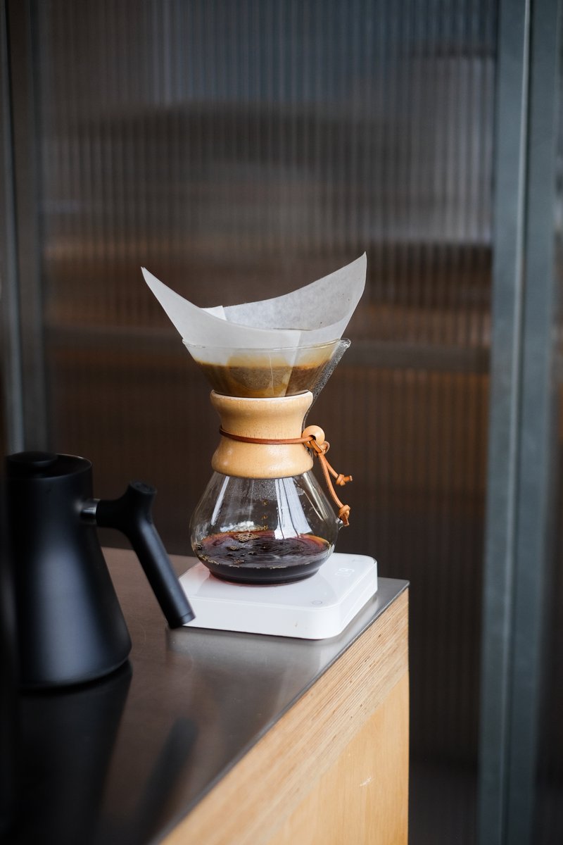 Sundays are made for sipping☕️ What's in your mug today? [Image description: A Chemex brewer placed on the Acaia scale, brewing in action on a metal counter. A Fellow Kettle is positioned in the background.]