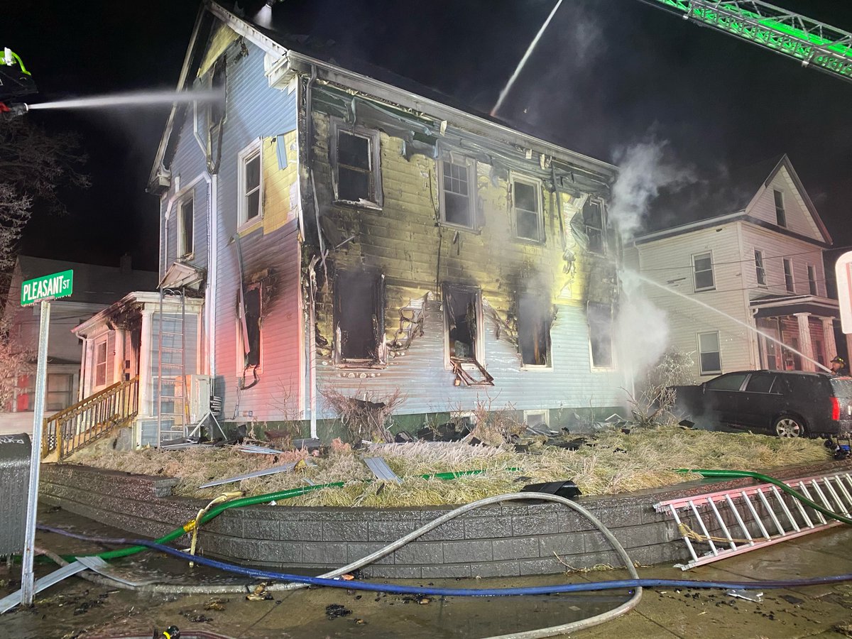 This evening, Medford firefighters fought a stubborn three-alarm fire in a two family home, at the corner of Riverside Avenue and Pleasant Street. Additional resources and tactics were needed due fire burning within hidden void spaces and internal staircases/floors being