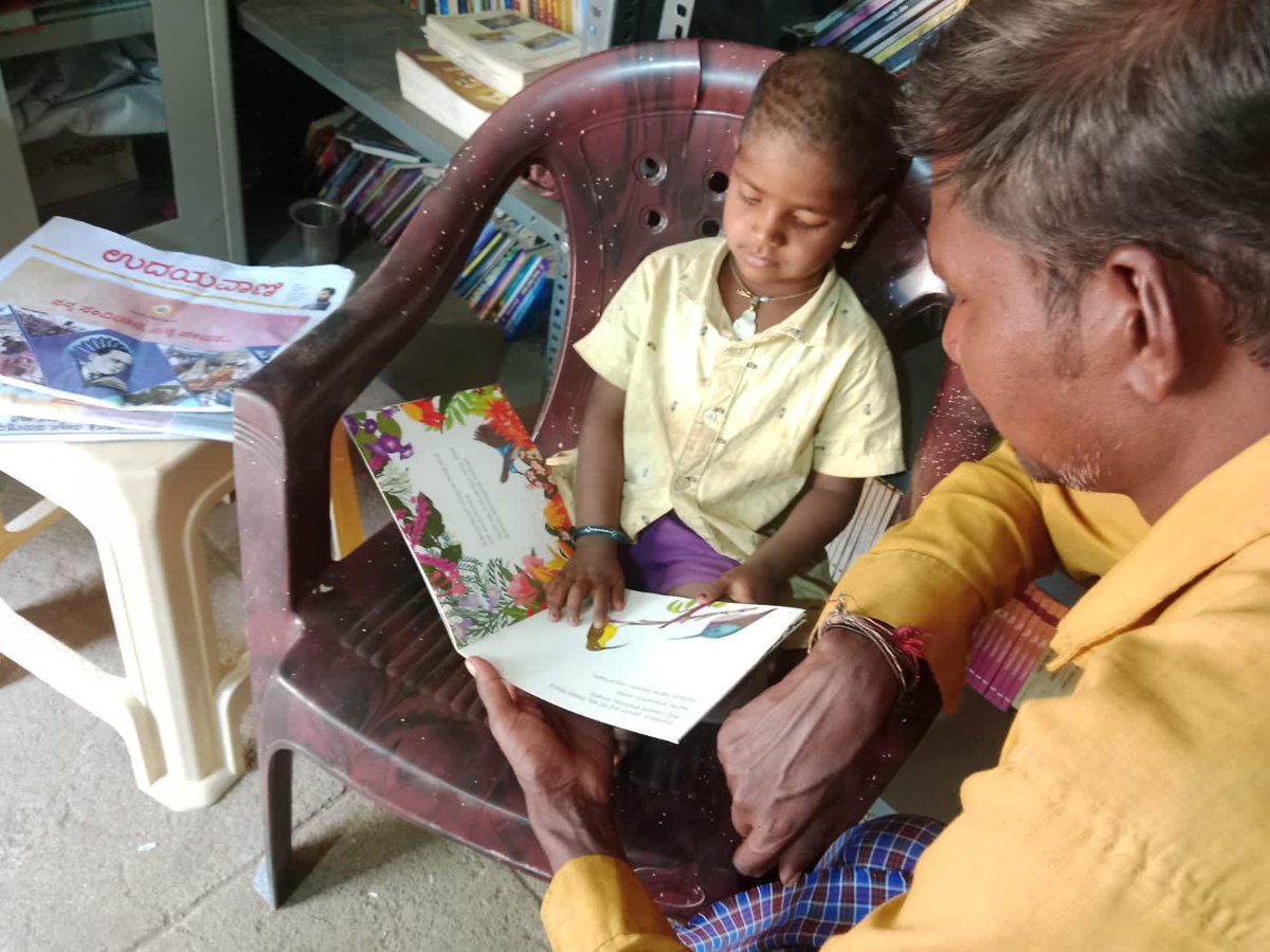 Father and child reading together in the rural library. 

#kidsinlibraries #readingtogether