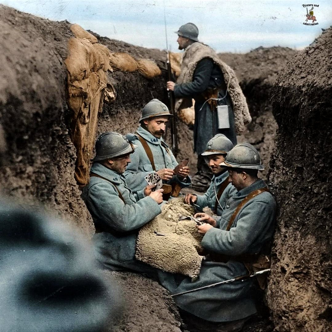 French soldiers of the 49th Infantry Regiment playing cards in the trenches in the winter of 1916