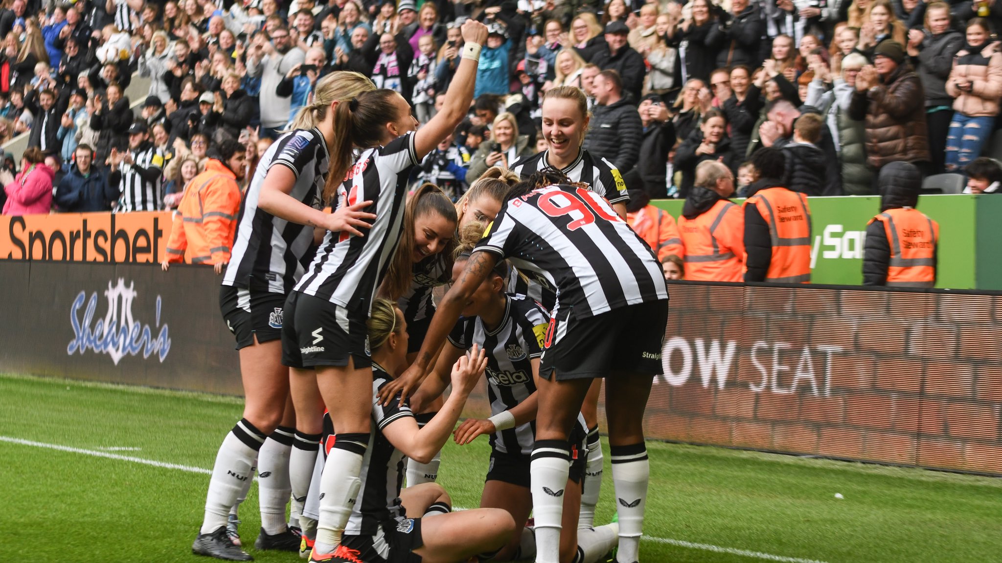 Newcastle United Women’s players celebrate at St. James’ Park.