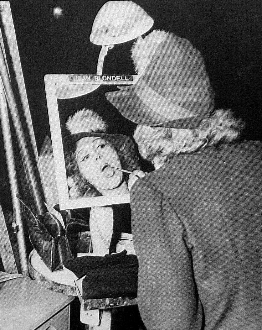 Joan Blondell touches up her makeup in between scenes on the set of EAST SIDE OF HEAVEN (1939).