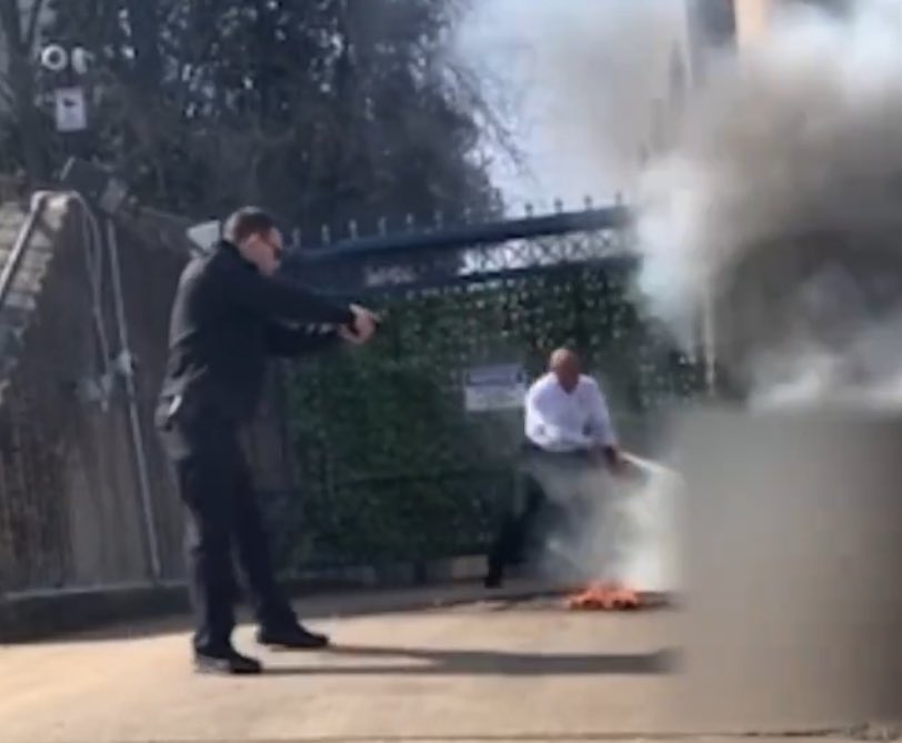 A cop pointing a gun at a guy who’s on fire is the most American thing ever