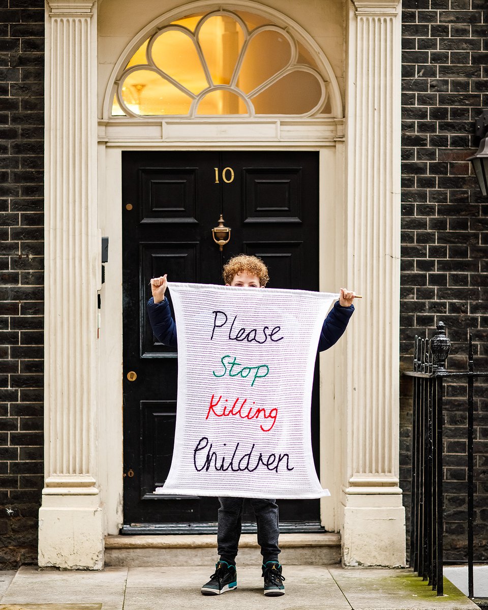 Please Stop Killing Children. As of 23 Feb 2024 14350 children have been killed by Israel in Gaza. We created this artwork in response - a banner made from a traditional white baby blanket with hand crocheted lettering (lovingly hand stitched by @joolshenry). #StopArmingIsrael