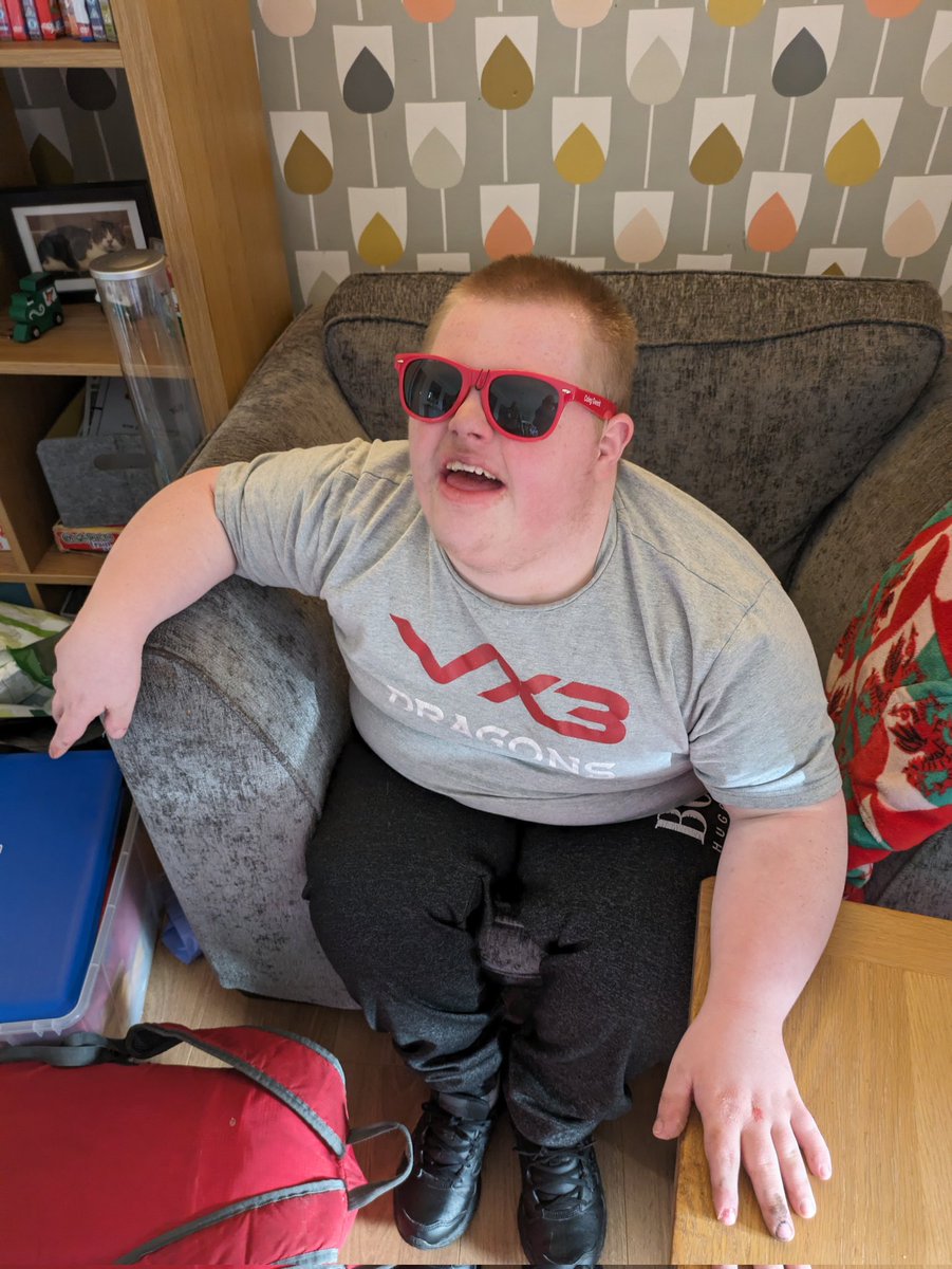 Home from respite and school. First things first, he puts his new @coleggwent @DRA_Community @dragonsrugby sunglasses on. Thanks again @MikeSage9
#DragonsFamily 
🐲