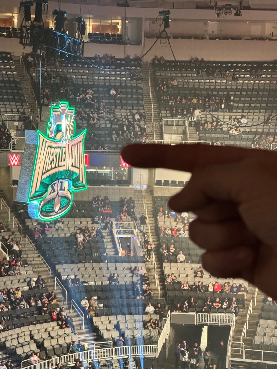 AndrewChampagne's tweet photo. Greetings from #WWERaw in San Jose! By pointing to the sign like so, I get a title shot, right?
(Tonight’s ensemble includes an @UpUpDwnDwn Uno t-shirt. My apologies to @RJCity1, as I figured wearing my “Hey! EW” shirt would’ve gotten me scolded by any Gagnes in attendance.) https://t.co/DsKYQyWpfx