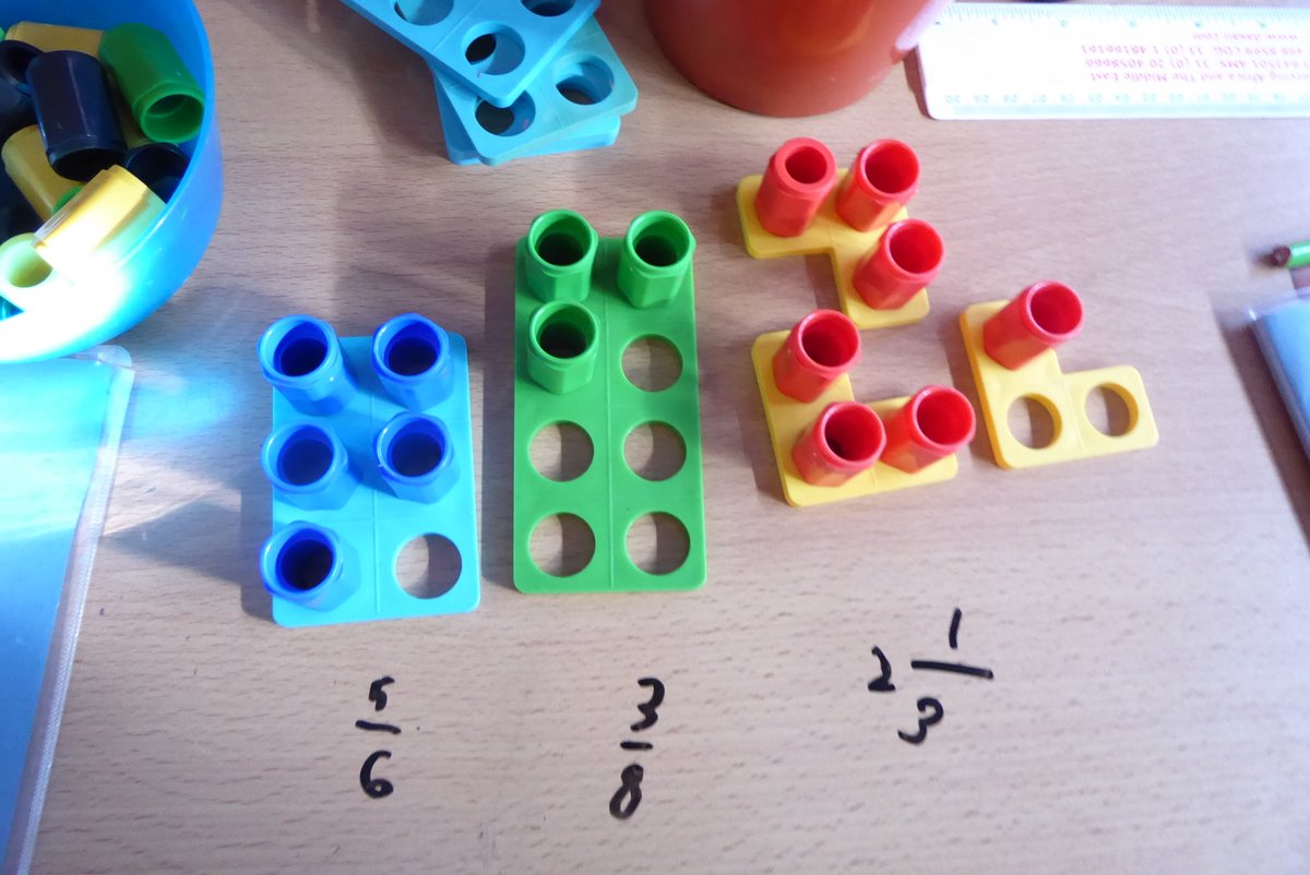 Using numicon to model fractions and show the denominator and numerator. @Numicon
