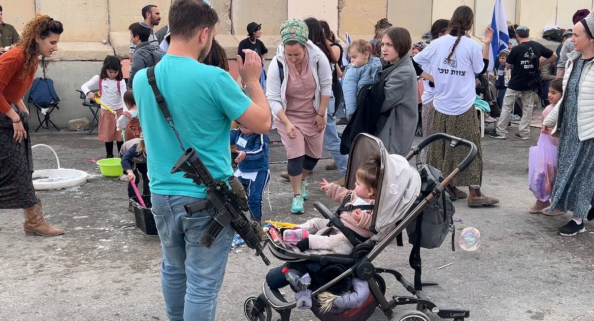 Today at the Nitzana border crossing Israeli citizens are bringing their machine guns and small children to block all humanitarian aid from entering Gaza. The military is having fun. The kids are cooking cotton candy.