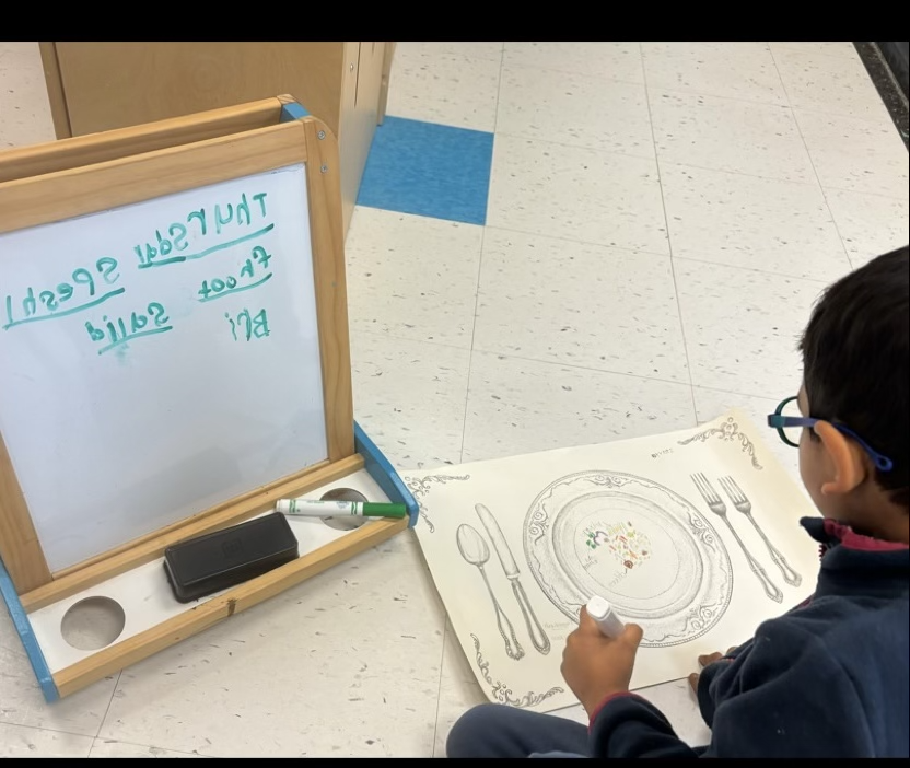 A student wanted to add biryani to the classroom restaurant's menu. He referred to his placemat activity where the word was already written, to help him spell biryani correctly. @EY_uwindsor