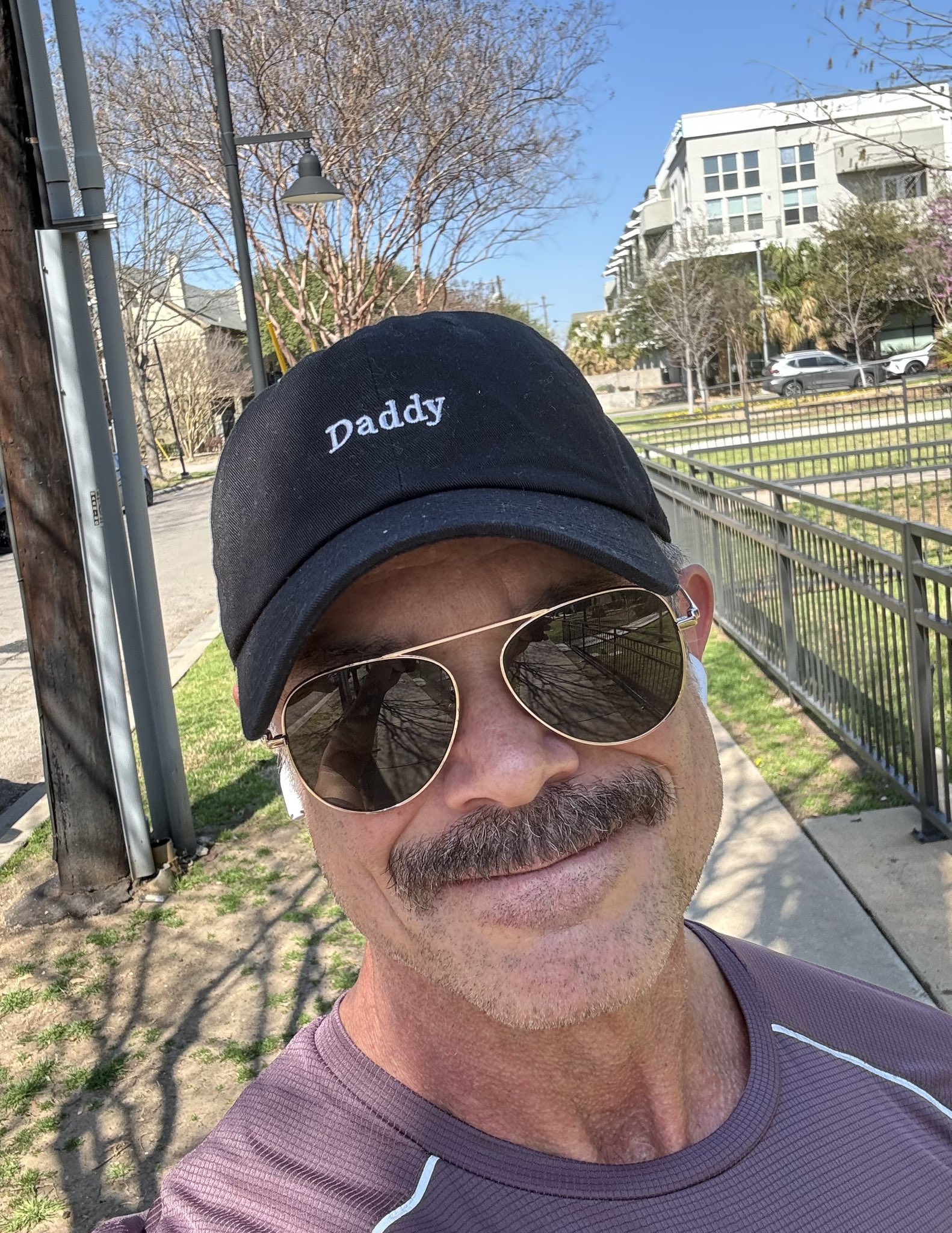 Face shot of Reece Scott outdoors wearing a hat that simply says "Daddy."