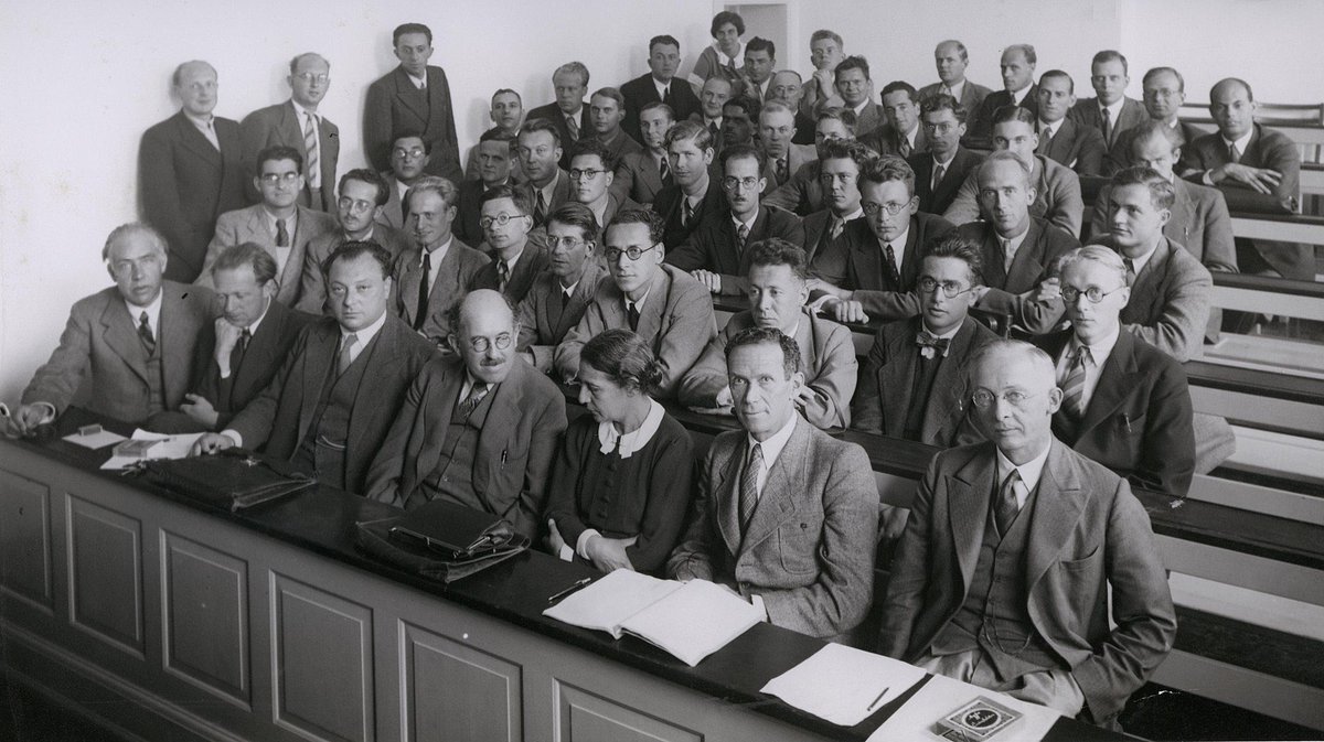 At a conference in 1937, Lise Meitner shares the front row with [L-R] Niels Bohr, Werner Heisenberg, Wolfgang Pauli, Otto Stern and Rudolf Ladenburg; Hilde Levi (in the top corner) is the only other woman in the room.