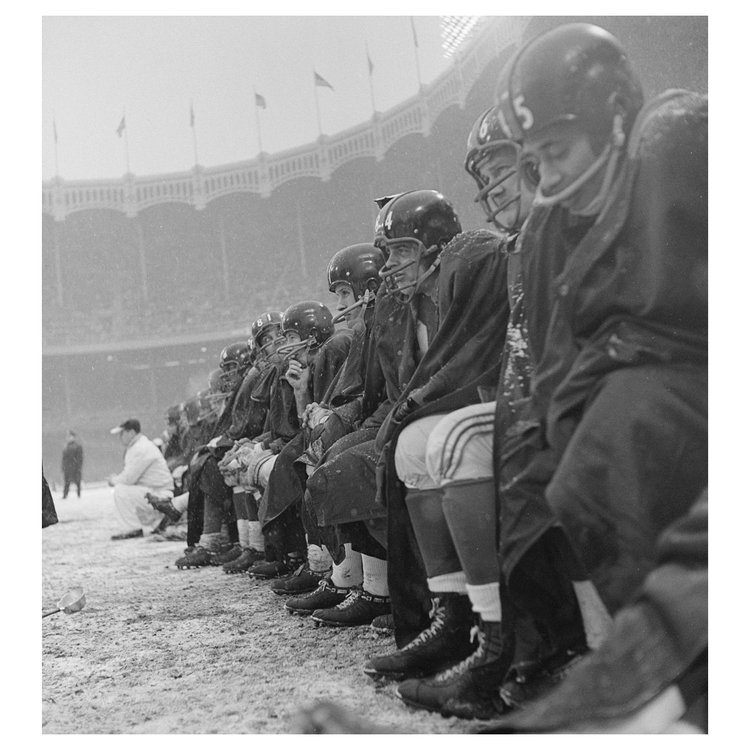 New York Giants players sit on the bench during a snowy game against the Cleveland Browns at Yankee Stadium.  This was shot two weeks before Neil’s was 16th birthday. Bronx, New York. December 14, 1958.