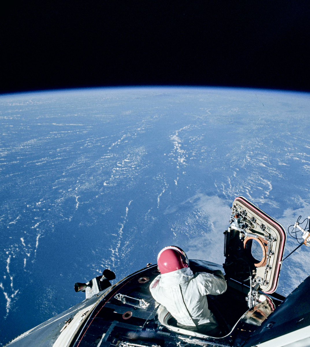 Apollo 9 CM Pilot Dave Scott taking a moment to enjoy a view of Earth from the open hatch of the CSM Gumdrop, at the time docked to the LM Spider and orbiting at an altitude of about 149 miles, on March 6, 1969 (From original NASA image AS09-20-3065)