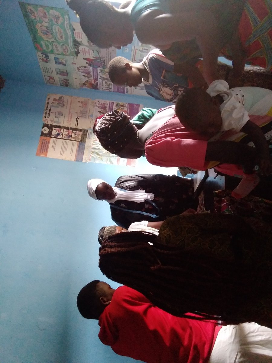 Happening now at Bwera United women with disabilities Association (BUDWA) women and girls doing fashion and design, tailoring class.cutting kitenge. Making a women dress