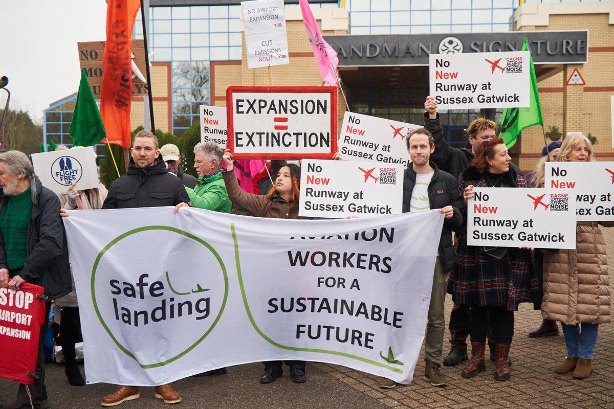 Protesters from many groups including Safe Landing, aviation workers for a sustainable future gather at Gatwick Airport