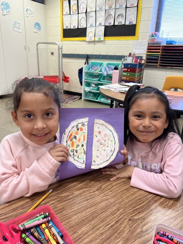 Students in Mrs. Tucker's kindergarten class are learning how to make fair shares by dividing one object (pizza) into equal halves.