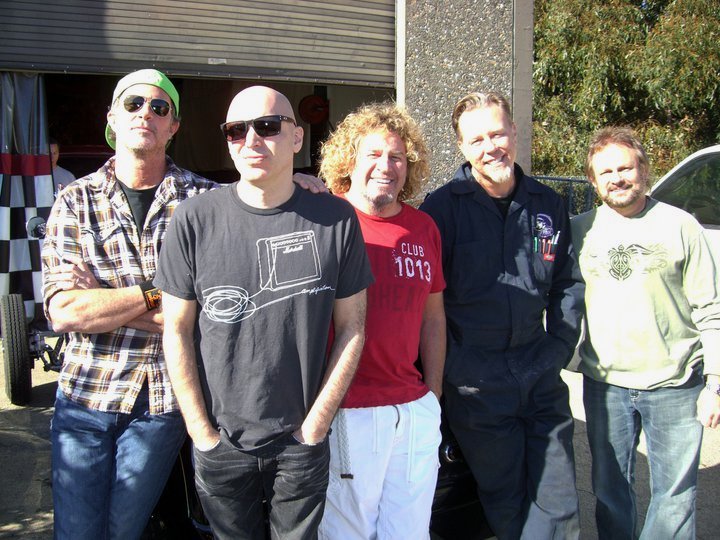 Just a bunch of shifty-lookin’ guys outside the venerable Franzini Brothers automotive restoration shop. We should have been busy recording but instead, we were checking out a cool ’73 Camaro. That’s where I got the idea for my “Hugger Orange” Ibanez JS guitar color. - Joe