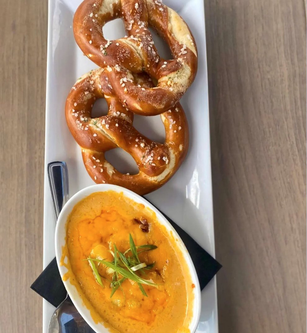 Our signature Cheese Dip - made with real Aged Cheddar, Candied Bacon; Blindman Brewing Longshadows IPA in Lacombe and Sawback Brewing Co. West Coast IPA in RedDeer! 🧀🥓 Served again with Salty Soft Pretzel twists 🥨 and paired perfectly with just about anything!