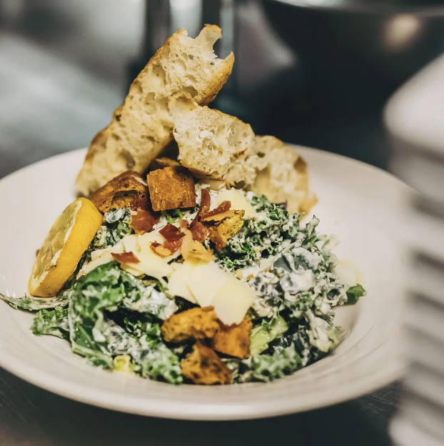 We didn't think you could love a salad this much! Our Rainbow Kale Caeser Salad chopped fresh rainbow kale mix tossed in our house-made caesar dressing, crumbled crisp prosciutto, herb focaccia croutons, asiago cheese, caramelized lemon wheel, and toasted garlic focaccia 💯