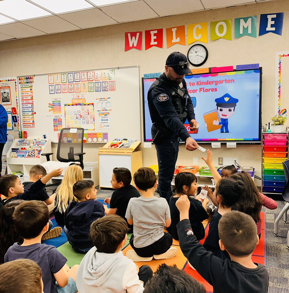 Hats off to <a href="/MenifeePD/">Menifee Police Department</a> Officer Flores for reading to our <a href="/HarvestHawks/">Harvest Valley Elementary</a> kindergarten students. We enjoyed having you be our guest reader during Read Across America week.  Our <a href="/RomolandSD/">Romoland School District</a> students loved the stickers they got at the end of the read aloud.