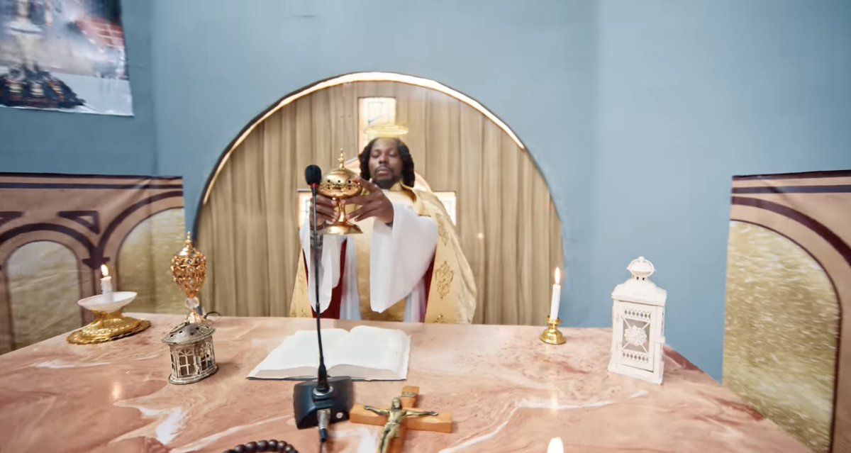 HarmlessHQ's tweet photo. This guy is a Muslim but he's ridiculing Christianity in his music video.

This is totally unacceptable and remains condemned in the strongest terms.

Why can't he do this nonsense with his Islam? https://t.co/ZMmBKpXi84