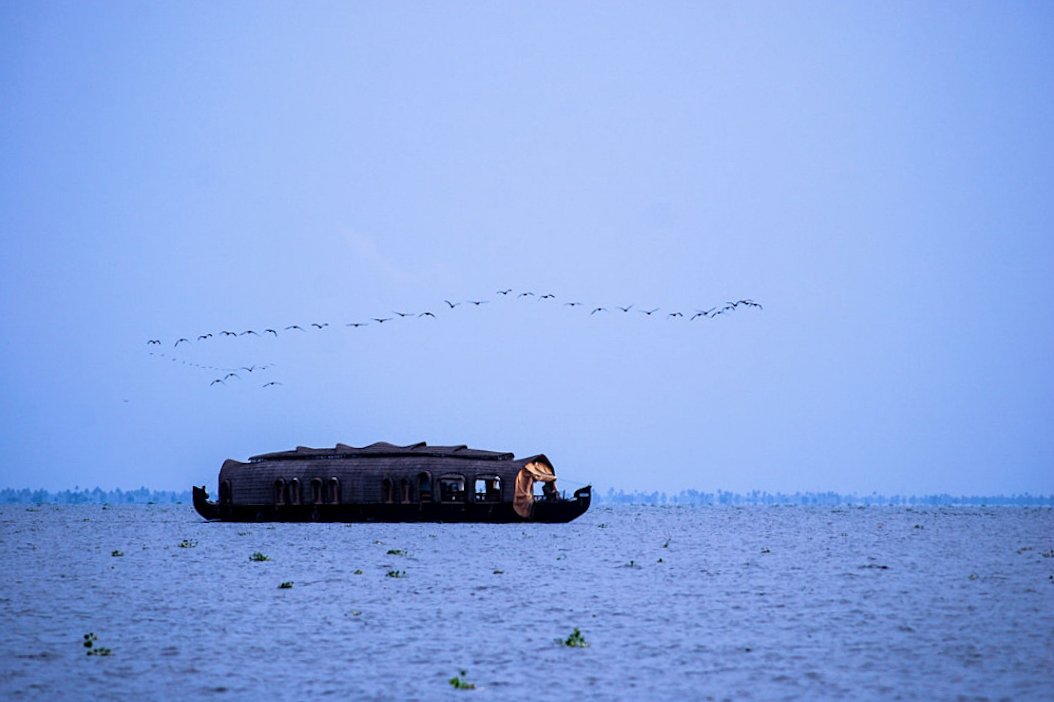 Houseboat in Vembanad lake during Monsoon season. Kumarakom, Kerala, India.