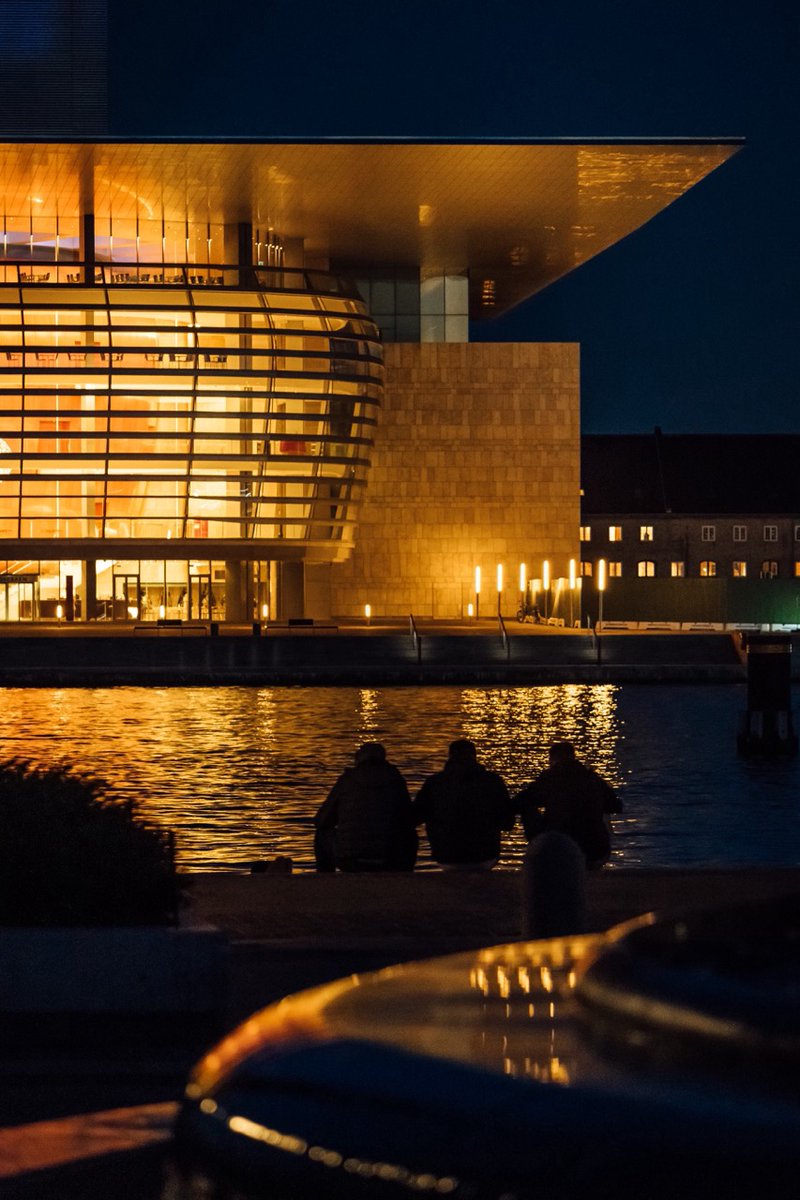 The Royal Danish Opera House (Operaen) stands majestically on the Waterfront with it’s modern architecture, inviting visitors to experience world-class opera and ballet in a setting that blends art with the beauty of the harbor and architecture. #visitcopenhagen #laravellivedk
