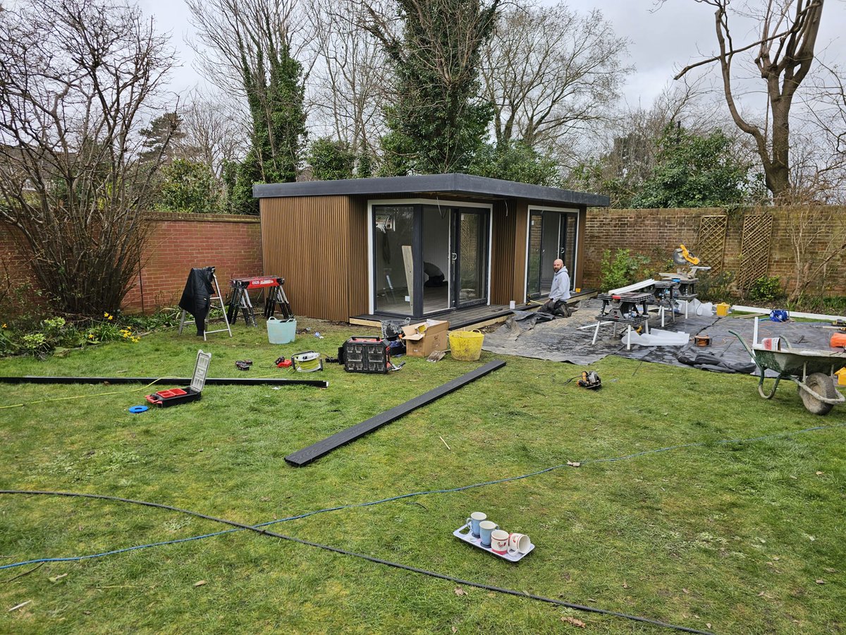On site this week in #Epsom, #Surrey. Day one laying out the base & day 4 starting to come together. 7.5m x 4m #gardenroom, upvc anthracite doors and windows, composite, slatted cedar cladding with a rececced door and overhang #gym and #office #bespokegardenroom
