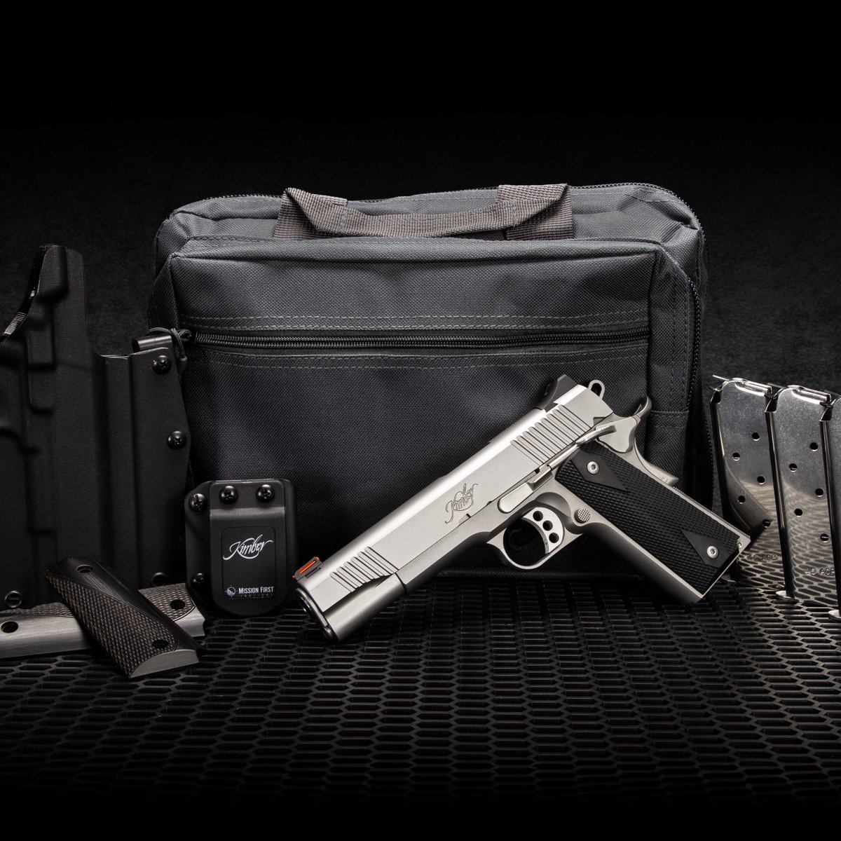 The Kimber Stainless II California Bundle- 1911 Stainless II, one set of black diamond wood grips, three 7-round magazines, one Mission First tactical holster, and one Kimber range bag.