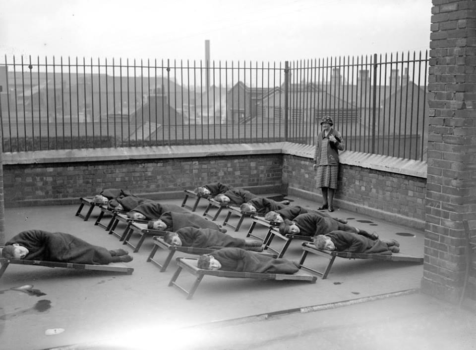 Children sleeping on the roof of a school, for orphans, 1920s.
