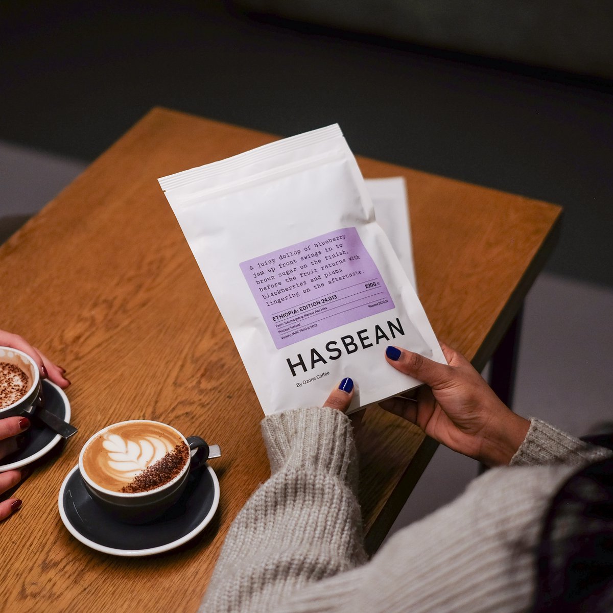 Warm their heart with delicious coffee – a gift that says 'you're cherished’ every morning☕ [Image description: A person holding a bag of Ethiopia: Edition 24.013 with a cup of cappuccino.]