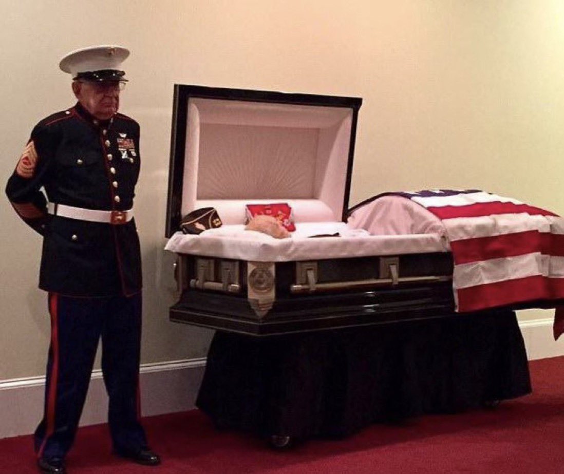 MorbidKnowledge's tweet photo. In a 2017 photograph, 83-year-old retired Marine Sgt. William H. Cox is seen faithfully standing guard for his comrade, Sgt. James 'Hollie' Hollingsworth, one final time. 

This enduring bond originated in 1968 when they first crossed paths while seeking refuge from rockets and mortars in a bunker. 

Within those bunker walls, the two men forged a solemn pact: should they both emerge from the war alive, they vowed to reconnect every New Year's Eve for a heartfelt conversation. 

This heartfelt tradition persisted for an incredible five decades.