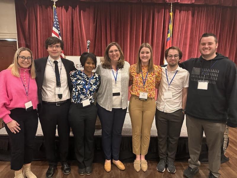 EcuLehe's tweet photo. ECU #HIED Student Ambassadors Lydia Surprenant, Lucas Madden, Delicia Cherry, Alex Schweitzer, Remington Sullivan, & Ryan Keller, along with Dr. Jenni Gallagher, participated in the @NCCSS Conference in Greensboro. πππ @ECU_COE #ECUHistoryEducation https://t.co/gbqmVKzvPA https://t.co/wg6hPqhMwr
