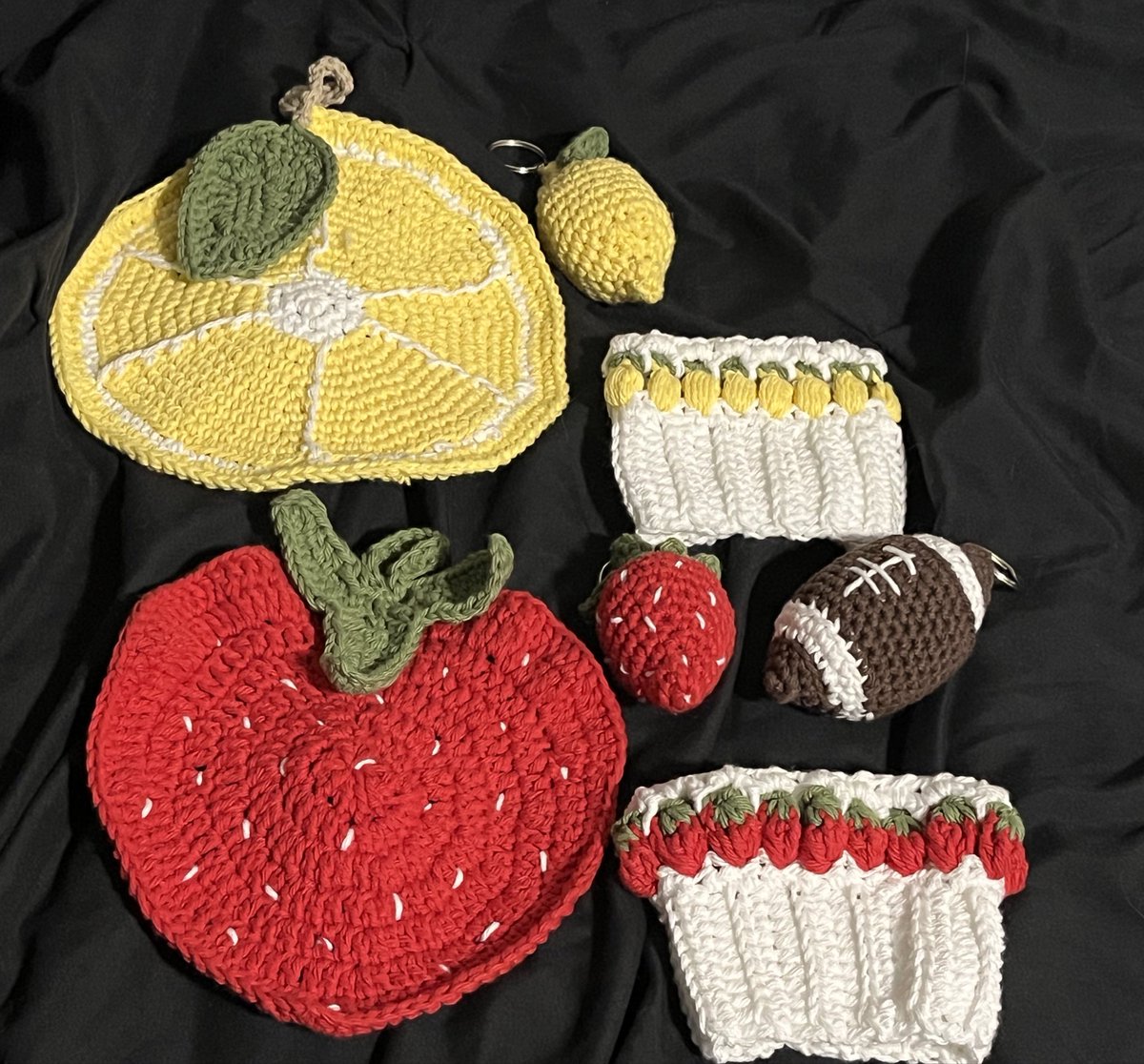 in unrelated news that nobody asked for: family friend asked for crochet items to sell at her lemonade stand for football season so i’ve been making keychains, potholders, and cup cozies. some are original patterns :3