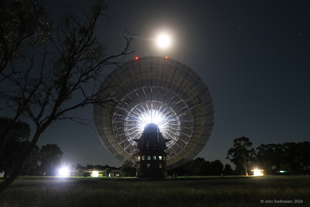 Odysseus and The Dish Murriyang, the CSIRO’s Parkes Radio Telescope, points toward a nearly Full Moon in this image from New South Wales, Australia, planet Earth. Bathed in moonlight, the 64 meter dish is receiving weak radio signals from Odysseus, following the robotic lander's…