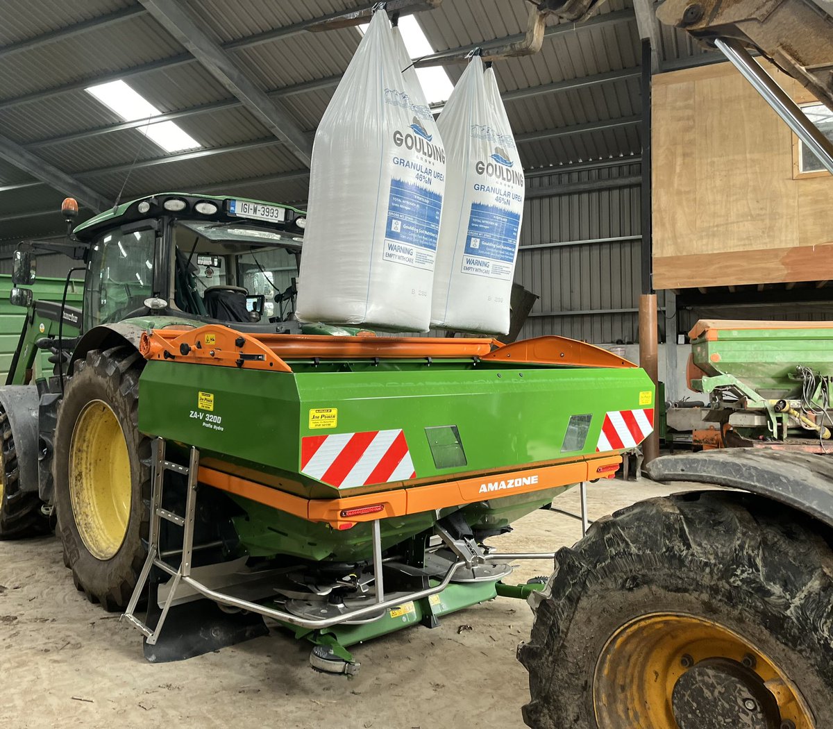 Loading the spreader indoors to dodge the showers ☔️